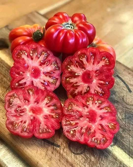 Sliced heirloom tomatoes on a wooden board